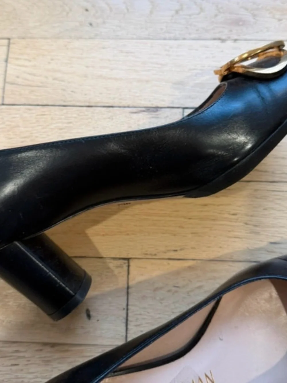 Stuart Weitzman Black Leather Pumps with Gold Buckle Accent